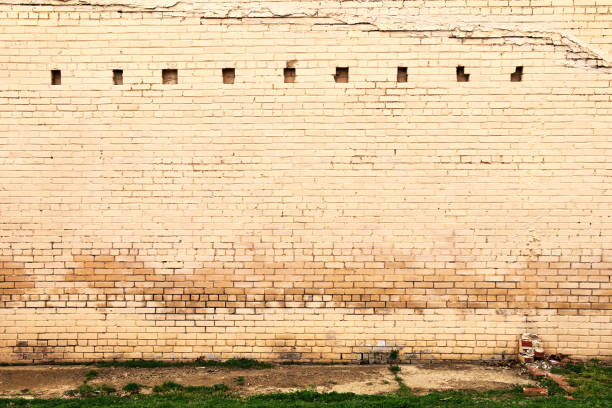 istock faded weathered painted stone brick warehouse wall 1215966870