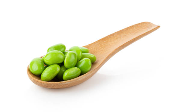 istock green soybeans in wood spoon isolated on white 1215966932