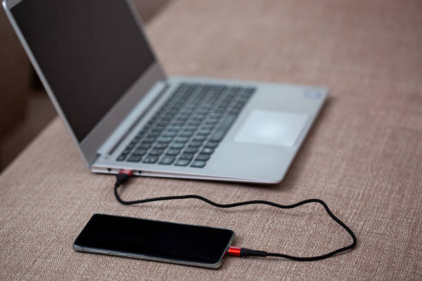 istock Phone connected to a laptop. 1215967286