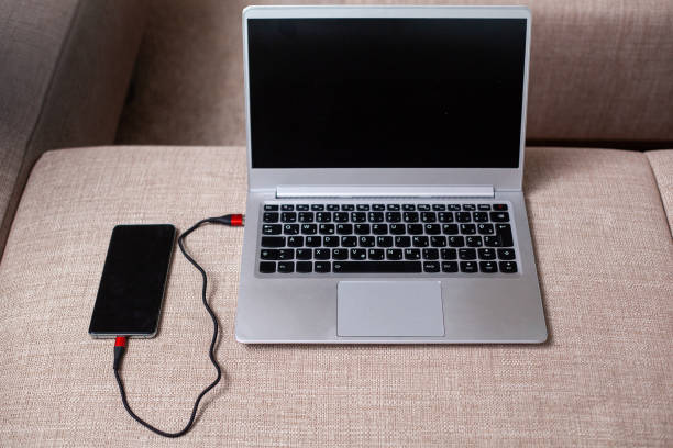 istock Phone connected to a laptop. 1215967300