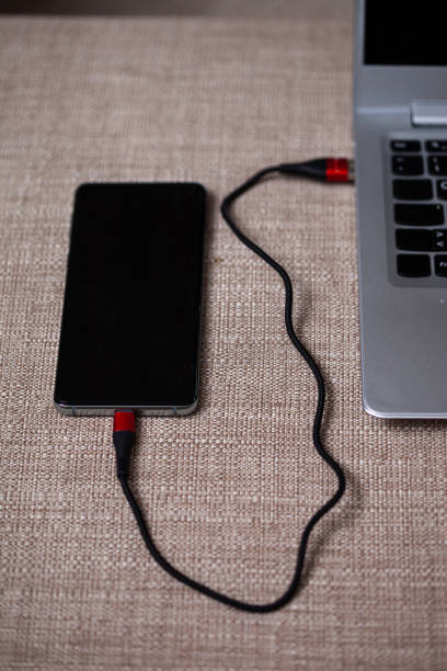 istock Phone connected to a laptop. 1215967317