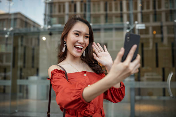 istock Beautiful girl talking over phone in town 1215968596