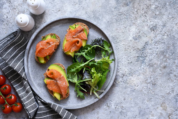 istock Toast with salmon and salad on a concrete plate, top view. Breakfast. 1215969977