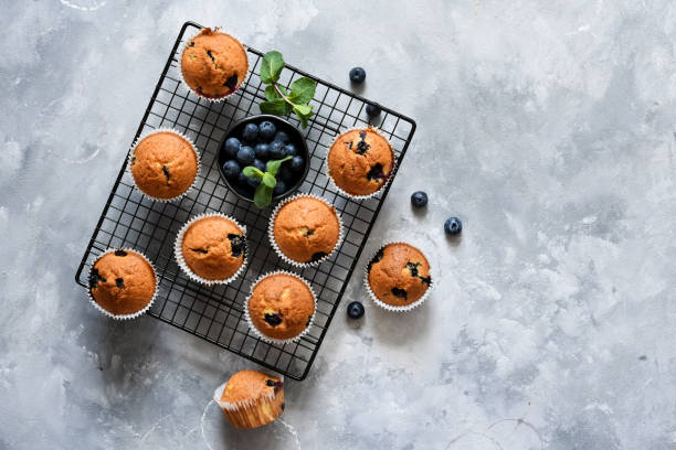 istock Vanilla muffins with blueberries on a concrete background. View from above. 1215970426
