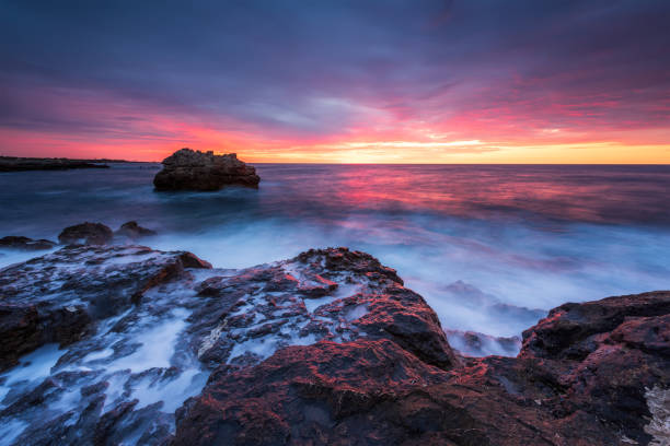 istock Sea sunrise at rocky coastline 1215973994