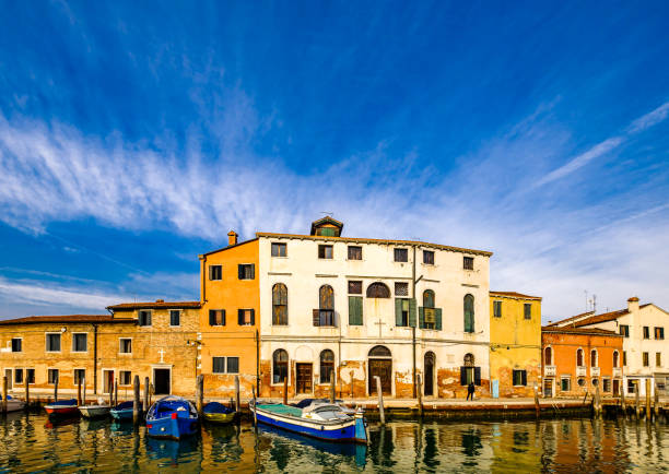 Houses peeling off from dampness. Venice is situated across a group of islands that are separated by canals and linked by bridges. Gondola is a traditional, flat-bottomed Venetian rowing boat