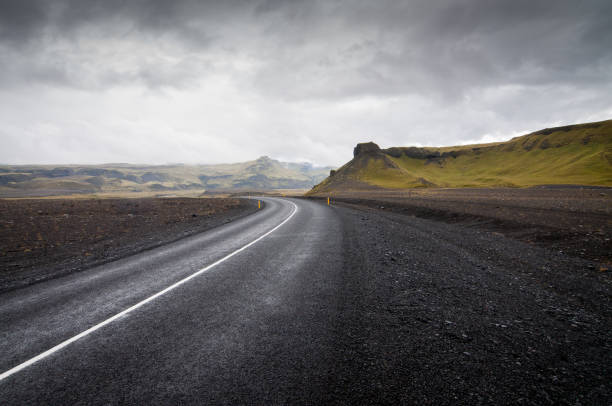 istock Black road with green mountains 1215976303