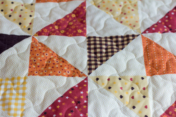 istock A patchwork quilt or bedspread.A fragment of a patchwork quilt as a background. Colored patchwork quilt. Colored blanket. 1215977251