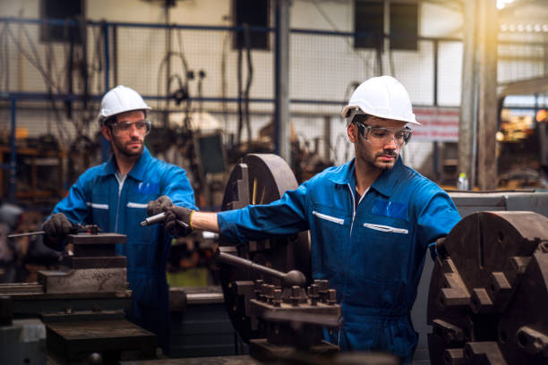 istock Professional technicians and two engineers are working in industrial plants. Professional technicians and engineers are working in fatory plants that work on steel. Working together. 1215977909