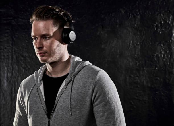 istock Young man wearing headphones 1215979253