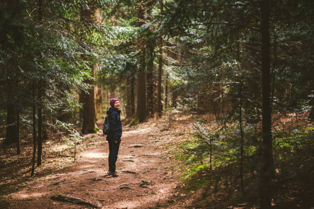 istock Smiling Woman in forest 1215979318