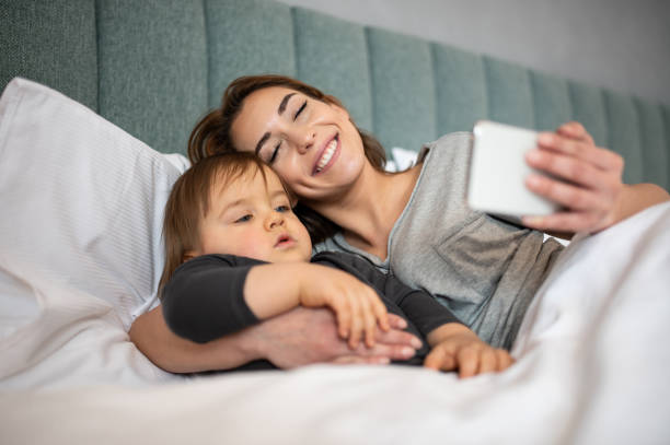 istock Mother and son watching their phone. 1215979596