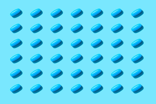 istock Repeated Pills on Blue Color Background 1215981875
