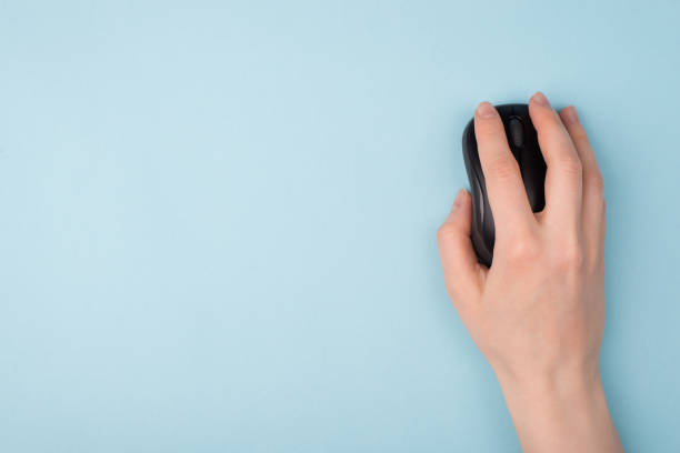 istock Top above close up view photo of hand using wireless computer mouse for searching necessary information isolated pastel color background 1215983429