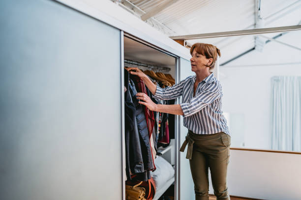 Woman taking clothes from the wardrobe