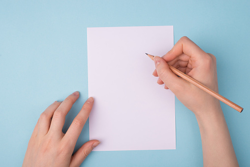 Writing application form or resume cv. Pov first person top above overhead closeup view photo of hands using wooden pencil for taking notes isolated over background empty blank space