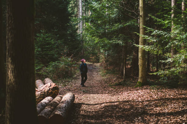 istock Woman With Backpack Hiking In The Forest 1215984641