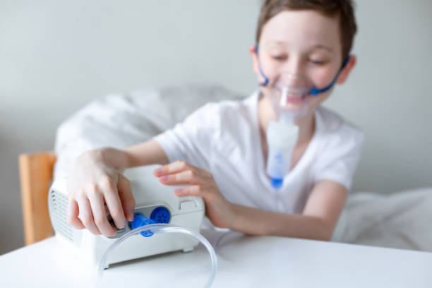 istock Portrait of kid boy using oxygen mask. 1215990105