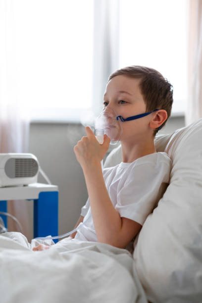 istock Portrait of kid boy using oxygen mask. 1215990639
