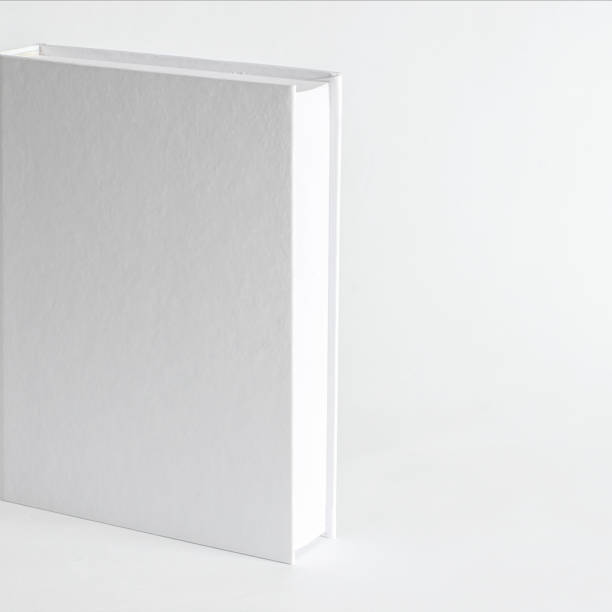 istock Mockup of closed blank square book at white textured paper background 1215990652