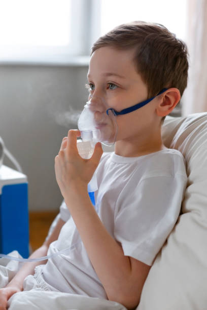 istock Portrait of kid boy using oxygen mask. 1215990653