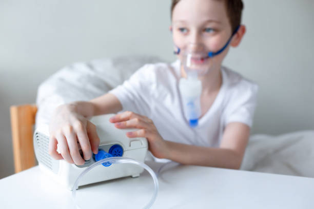 istock Portrait of kid boy using oxygen mask. 1215991028