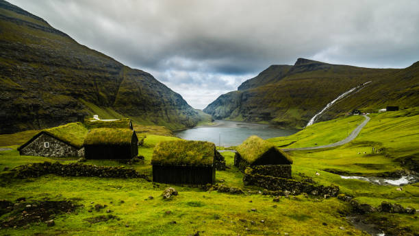 View on houses of Gjogv at Eysturoy island at summer, Faroe Islands. View on houses of Gjogv at Eysturoy island at summer, Faroe Islands. eysturoy photos stock pictures, royalty-free photos & images