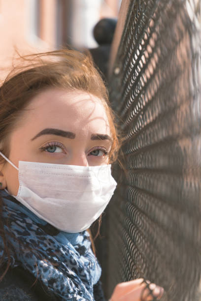 istock Woman in protective mask looking in the camera 1215991352