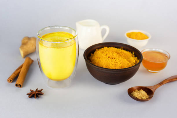 istock Golden milk, turmeric, honey, ginger root, cinnamon and other ingredients on grey table. Masala Haldi Doodh 1215991853