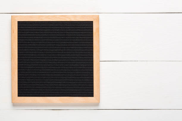 istock Empty black letterboard on white wood background. Design mockup 1215992362