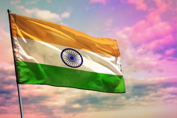 istock Fluttering India flag on colorful cloudy sky background. Prosperity concept. 1215992437