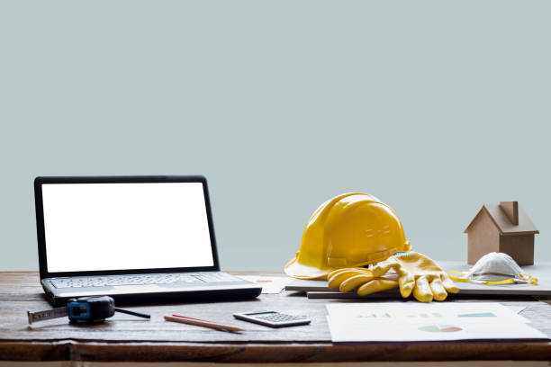 istock civil engineer helmet and laptop 1215993012