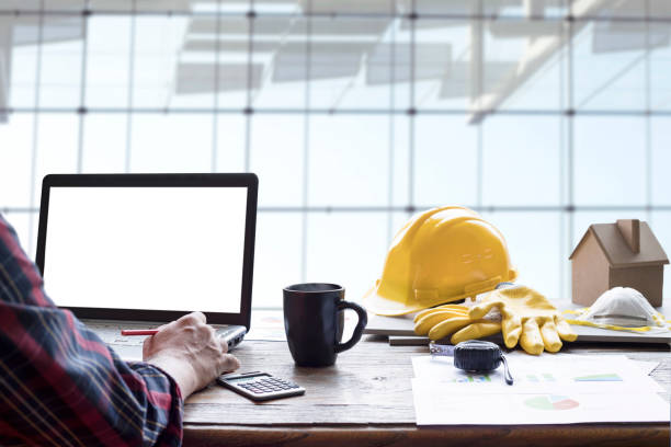 istock civil engineer helmet and laptop 1215993076