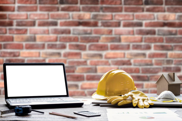 istock civil engineer helmet and laptop 1215993079