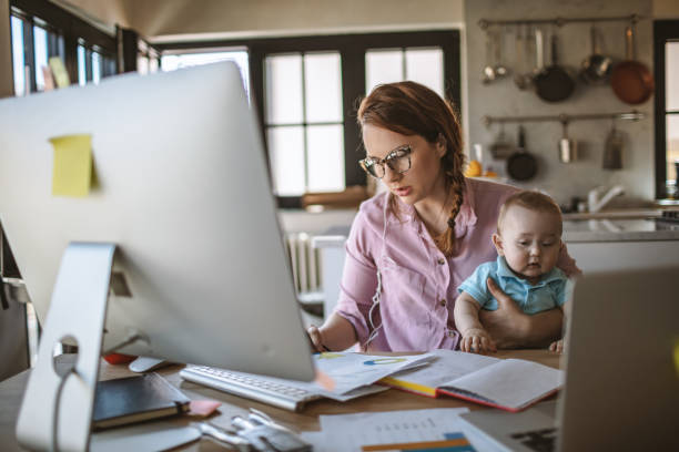 istock Mother with baby working from Home 1215997755