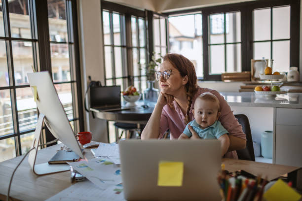 istock Mother with baby working from Home 1215997847