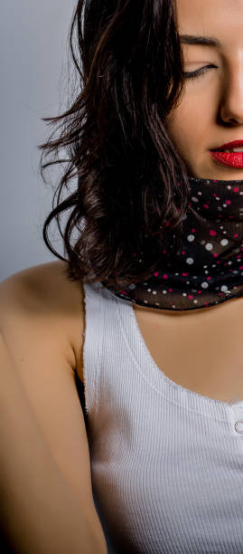 istock beautiful young model with black scarf 1215997878