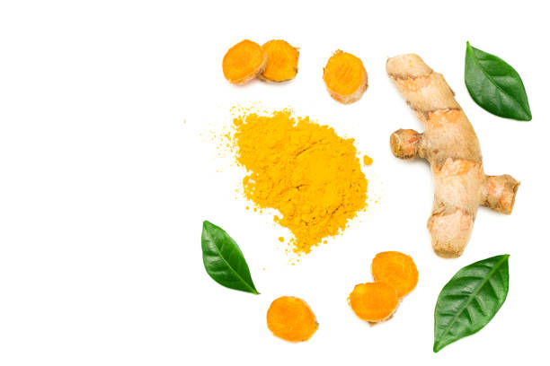 istock Turmeric powder with turmeric root isolated on white background. Top view. 1216001140