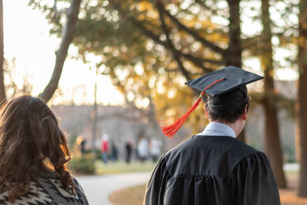 istock Rear View Of Students Walking In City 1216001436
