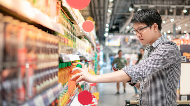 Asian man shopping orange juice using phone
