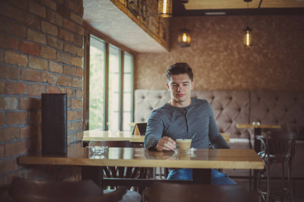 istock A young man sitting in a cafe 1216002558
