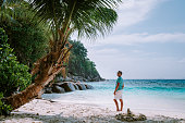 young men in swim short tropical beach Seychelles Mahe, Petite Anse tropical beach Seychelles