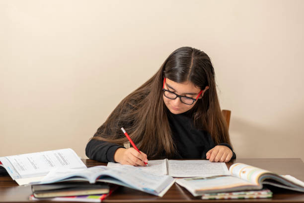 istock 13 years old girl doing homework 1216004400