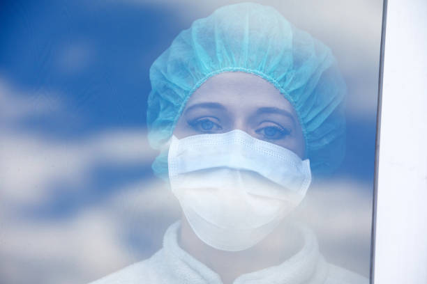 istock Woman with mouthguard looking through window 1216005684