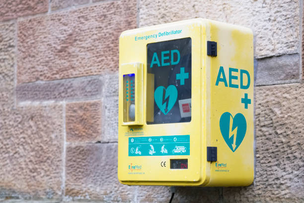 Defibrillator AED on wall in public space for emergency heart resuscitation London, England / UK - December 14th 2019: Defibrillator AED on wall in public space for emergency heart resuscitation defibrillator photos stock pictures, royalty-free photos & images