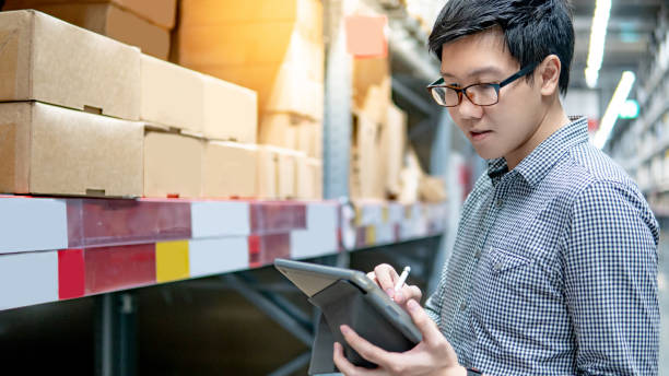 istock Asian man doing stocktaking on tablet in warehouse 1216007002