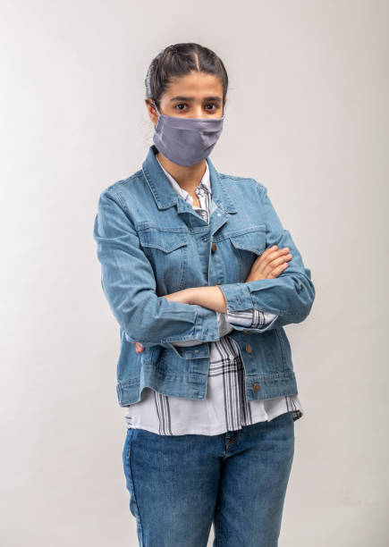 istock an Indian girl with protective mask on her face 1216008450