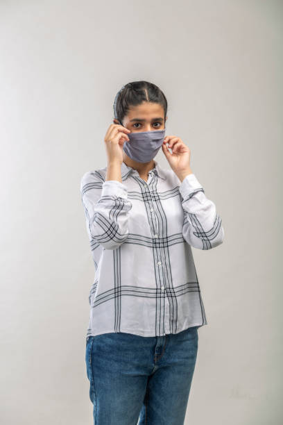 istock an Indian girl with protective mask on her face 1216008699