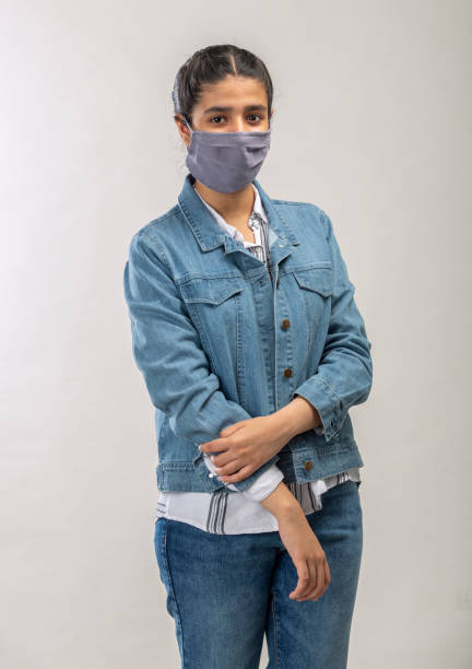 istock an Indian girl with protective mask on her face 1216008749