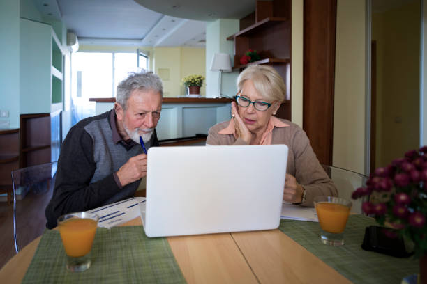 istock Senior Couple Calculating Domestic Bills. 1216008875